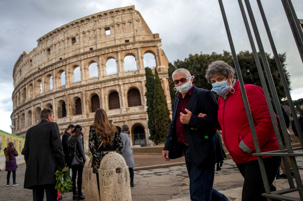 Tourists wear face masks as they walk close to the Colosseum in Rome, Italy.
Image from the New York Post (EPA)